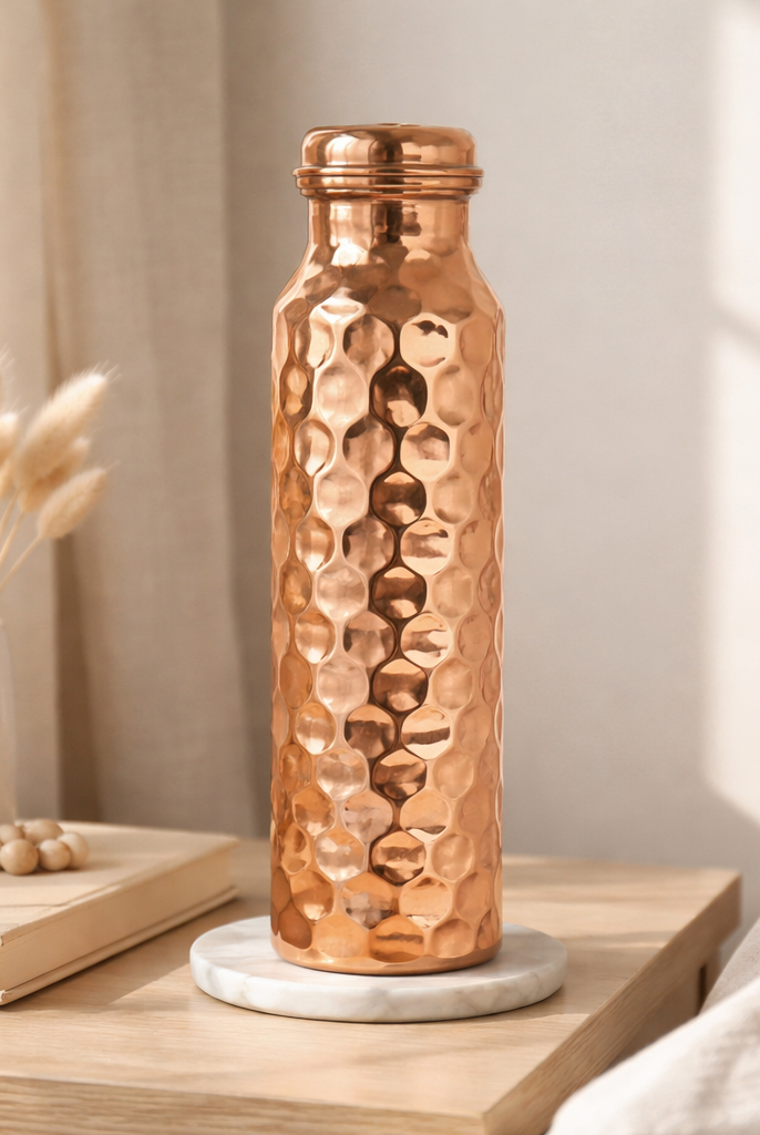 Elegant shiny polish copper bottle with a decorative textured surface.