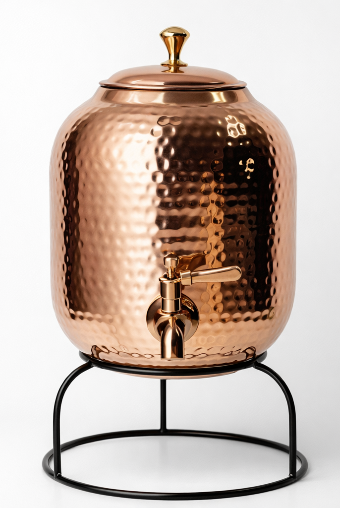 Close-up of a hand-hammered shiny polish copper water dispenser.
