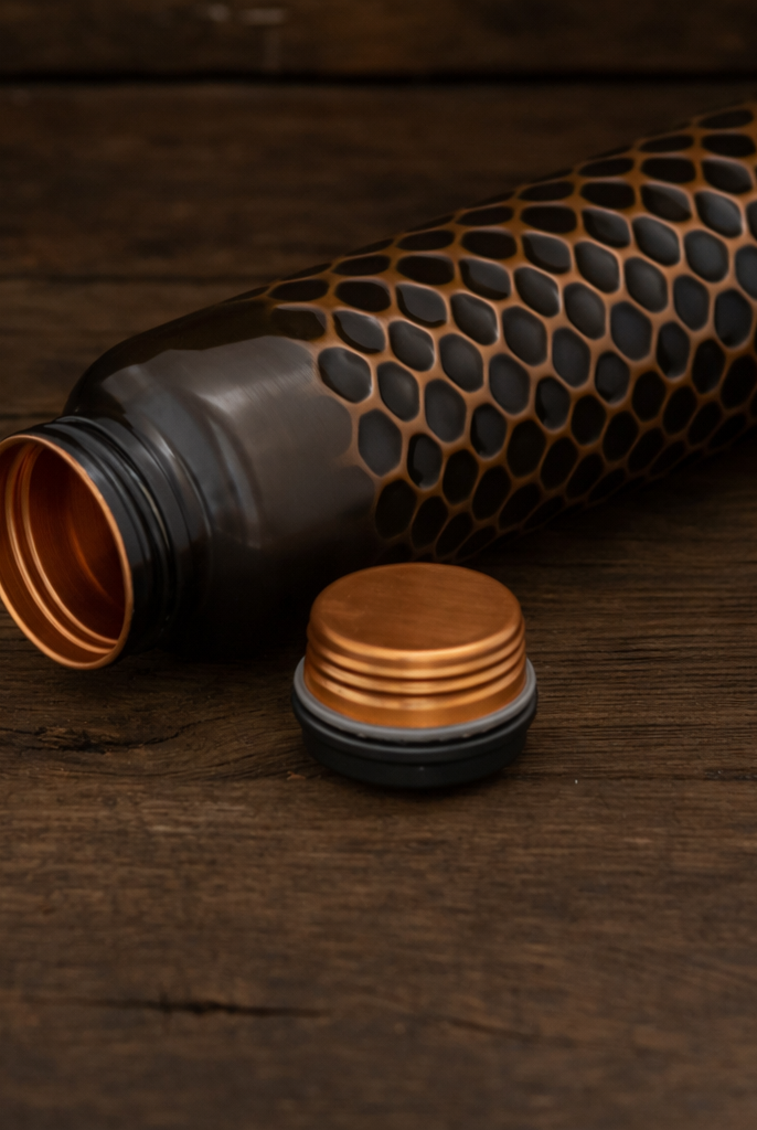 Handcrafted copper water bottle with detailed traditional embossing and antique polish.