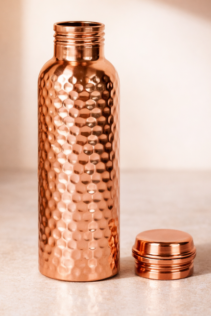 Close-up of the handcrafted hammered texture on a pure copper bottle.