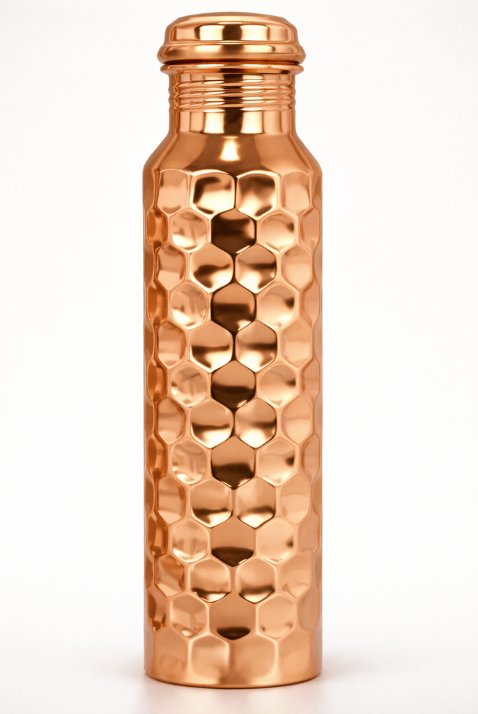 Close-up of the intricate hand-embossed design on a shiny copper bottle.
