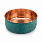 Hand hammered copper pedicure bowl with green patina outside and polished copper inside