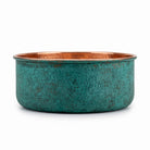 Side elevation of the copper pedicure bowl showing the straight sides and green patina