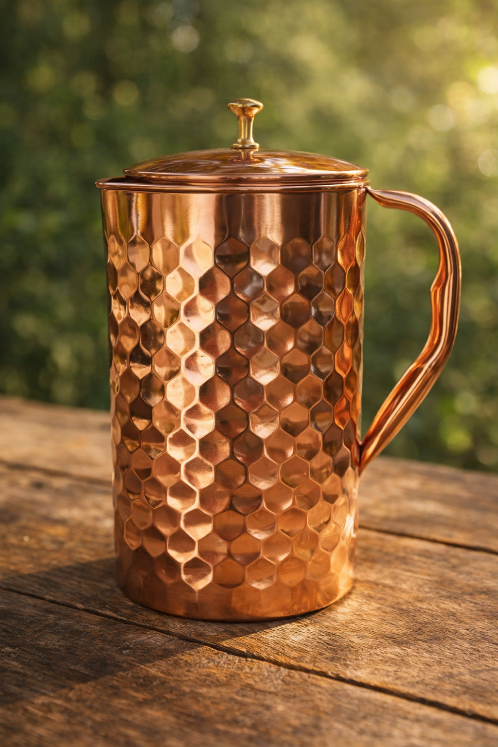 Diamond hammered pure copper jug with brass knob lid standing upright