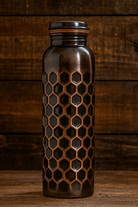 Pure copper water bottle with a rustic antique finish and embossed patterns.