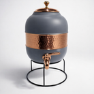 Close-up of a half-hammered copper dispenser showing the silk gray finish