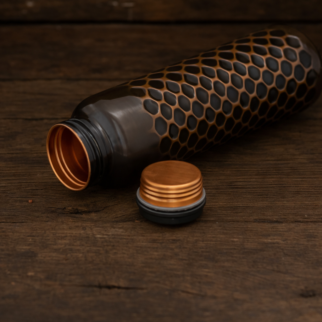 Handcrafted copper water bottle with detailed traditional embossing and antique polish.