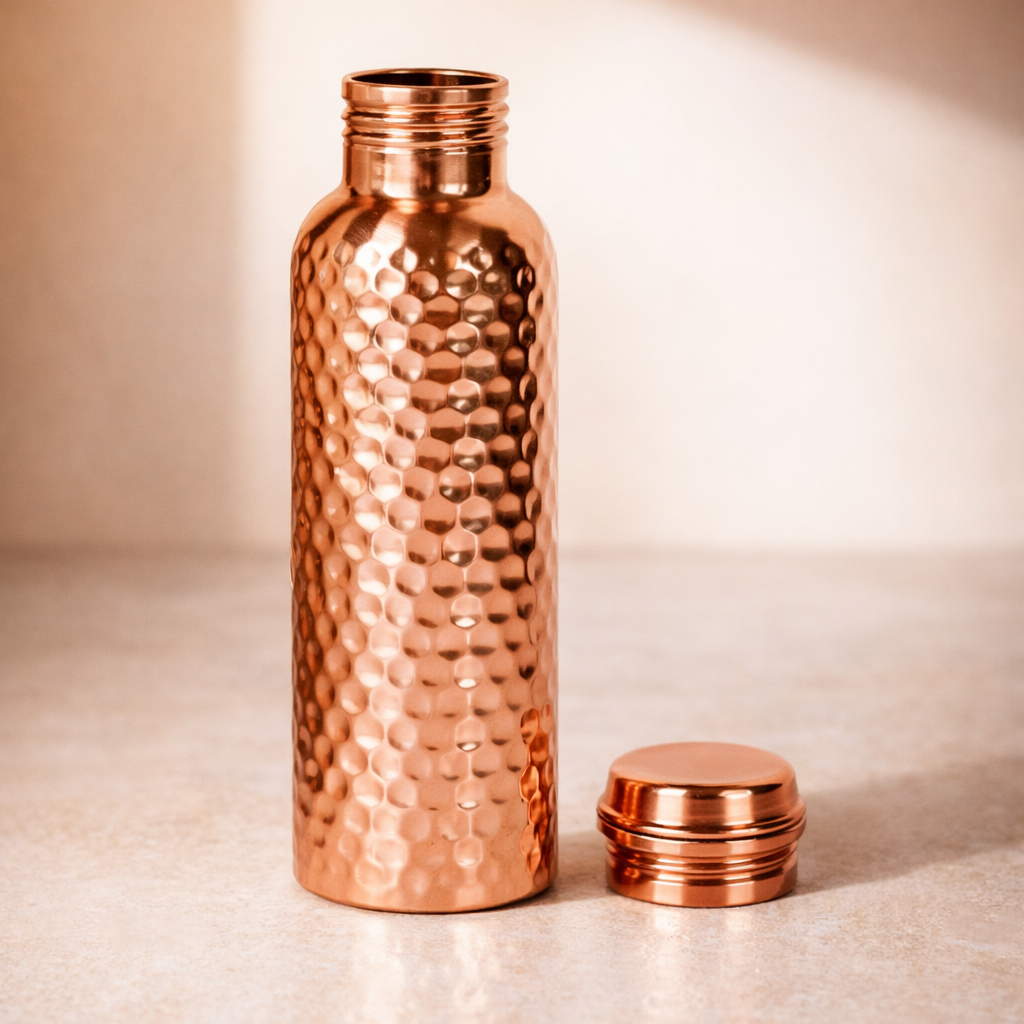 Close-up of the handcrafted hammered texture on a pure copper bottle.