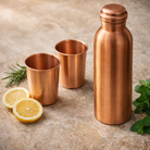 Pure copper drinkware set including one bottle and two glasses in matt polish.