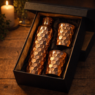 Shiny polish copper bottle and glass set featuring intricate embossed patterns.