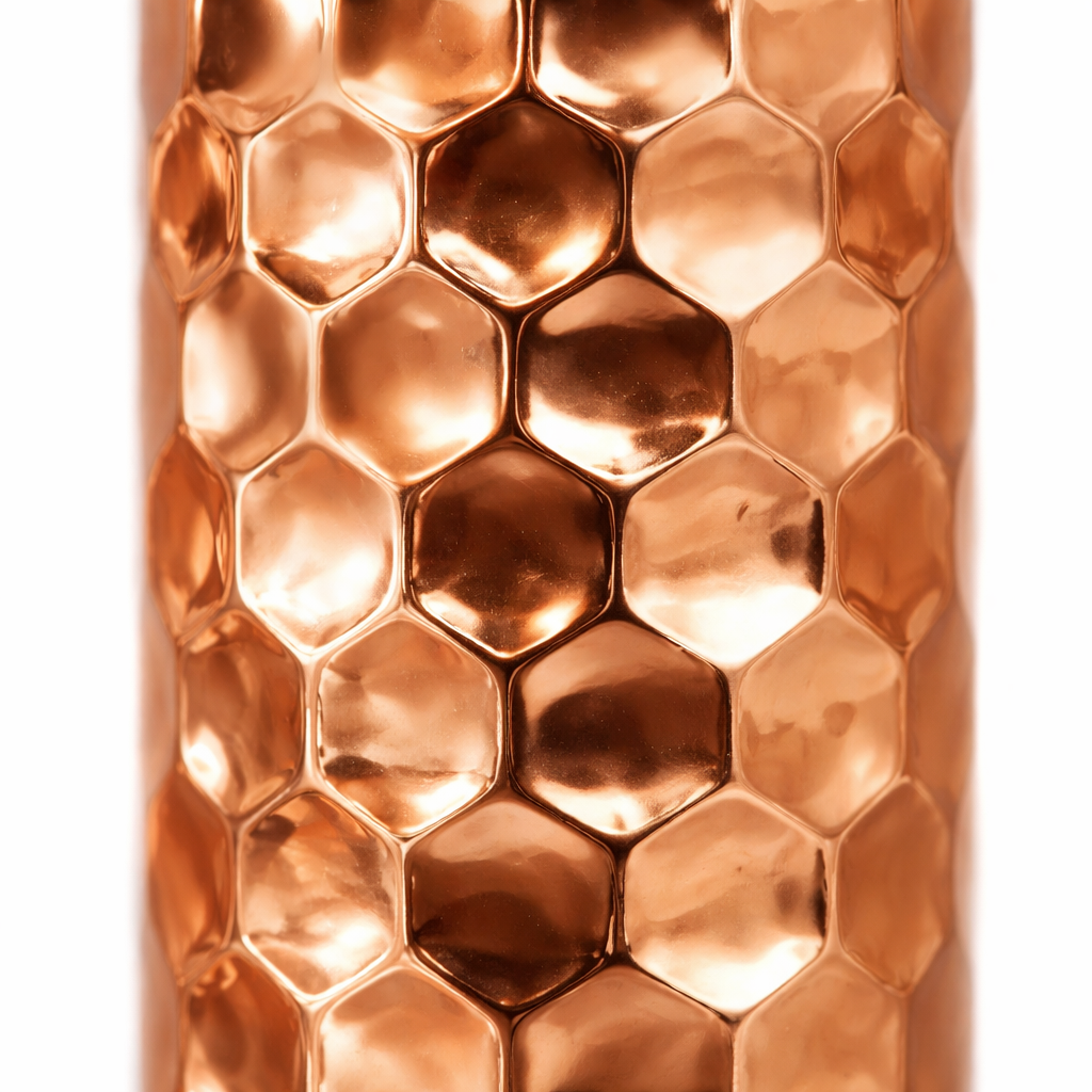 Reflective shiny copper water bottle featuring detailed embossed patterns.